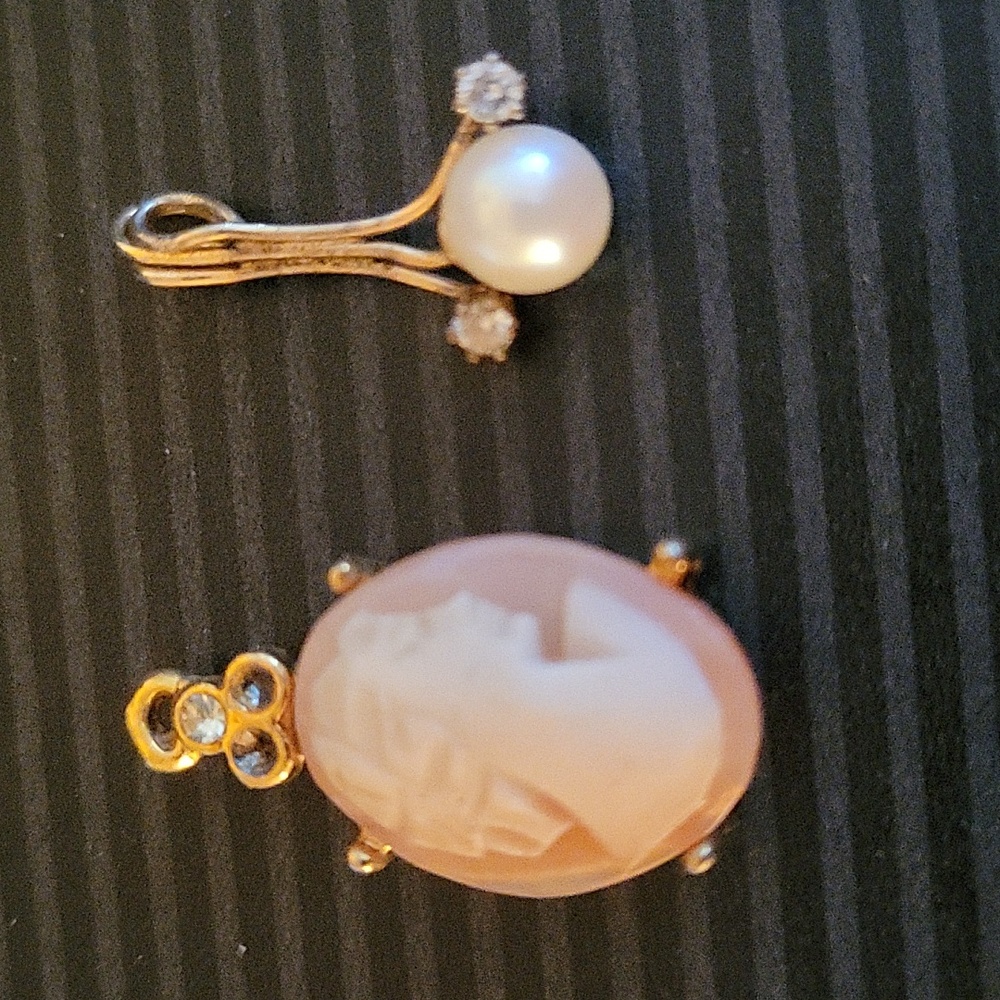 Two pendants. One is a Cameo and one is pearl and diamond.